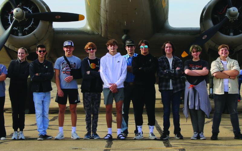 Cushing High School’s Aviation and Aeronautics club members admire a C-47 during the Cushing Fly-In Fair Saturday, Oct. 21. Pictured from left: Mylee Risenhoover, Emery Turner, Xander Williams, Wyatt DeLong, Kreed Wright, Roman Tucker, Trey Eaves, Tevin Minney, Korben Meloy, Lillyan Morlen, Damien Shelton, Dr. Jessica Sigle. Photo by Allie Prater
