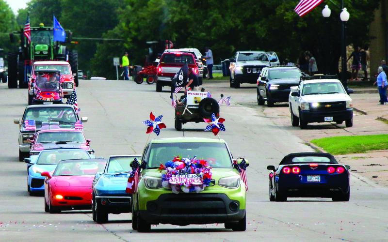Busy Bee Floral leads a string of would-be parade participants down Broadway following the cancellation of the parade on July 4th. Photo by Allie Prater.
