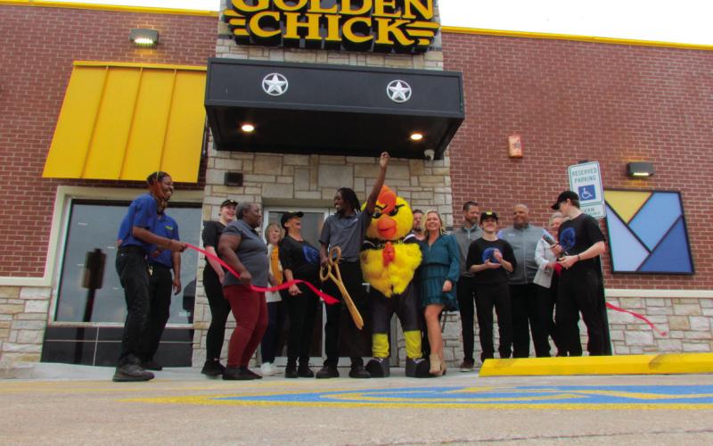 The official ribbon cutting for Golden Chick was held on Oct. 12 following the grand opening. Cushing Chamber of Commerce members as well as city officials and Golden Chick leadership, staff, and mascot Clucky were in attendance for the ceremony. Photo by DeAnna Maddox.