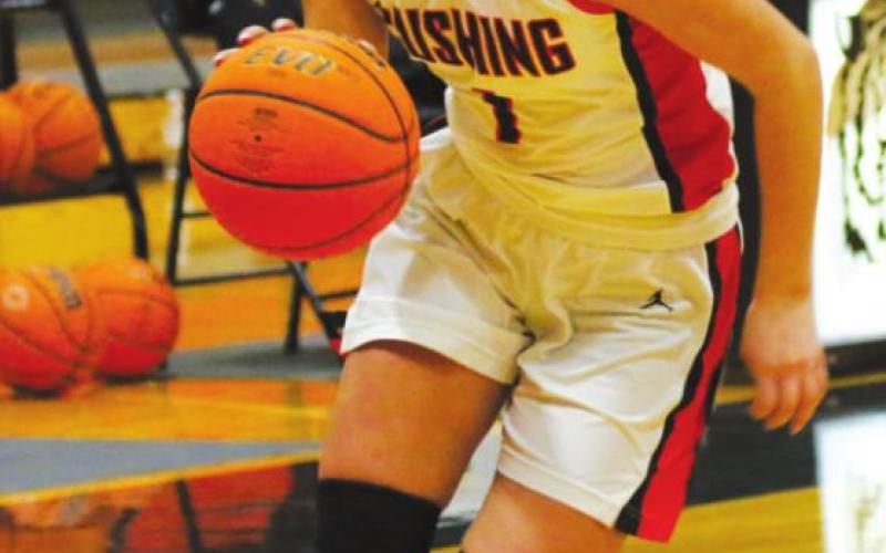 Right: Cushing’s Jayse Nicholas works her way inside. Nicholas scored 10 points Friday in the Lady Tigers’ game against the Lady Pirates of Bristow.