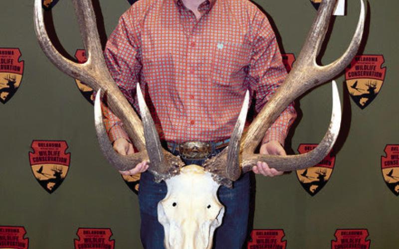 Zane Scrivner holds the antlers of the elk he took in September at Fort Sill. It is Oklahoma’s new record nontypical elk with a score of 411 1/8. (Photo by Don P. Brown/ODWC)