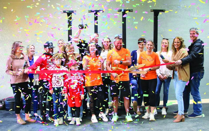 Tyler Ashbaugh, owner of Cushing CrossFit cuts the red ribbon for the grand opening of his new CrossFit gym in downtown Cushing, Friday Nov. 10. Cushing CrossFit is located at 114 W Broadway with classes available from 5 a.m. to 6 p.m. Photo by Allie Prater