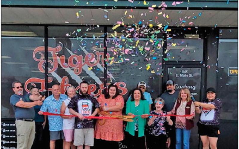 New owners of Tiger Nutrition and Tiger Fitness cut the ribbon during the reopening ceremony hosted by Cushing Chamber of Commerce members.