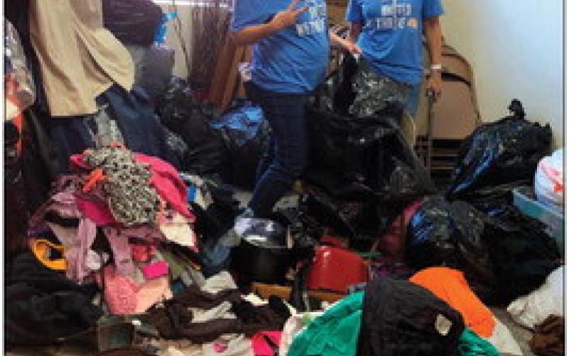 Bank of Cushing employees organizing the clothes closet at the First Christian Church.