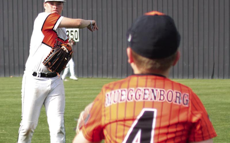 It was youth night at Tiger field Monday when the Cushing varsity baseball team hosted and warmed up with participants in Cushing’s youth baseball leagues. Above, Tiger Cooper Johnson is warmed by Terrick Meuggenborg, of Yale, who played in the Cushing 10-U league. Photos by J. D. Meisner