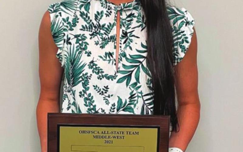 Kamryn James stands with her OHSFSCA All-State team Utility-Outfielder award for class 3 and 4A.