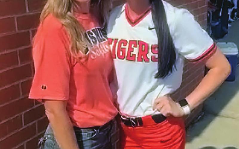 Kamryn James stands with Cushing high school softball coach Nikki York, at the 2022 class 3 and 4a All-State game.