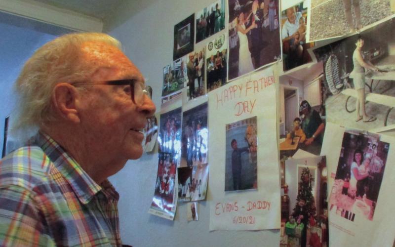 Earl Cates shows off his images of his family as he walks through his house. Photos by DeAnna Maddox