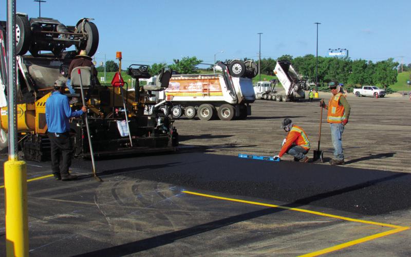 Crews were out at Cushing Wal-Mart on June 26 repaving a section of the parking lot to improve the surface to give locals a smooth ride to pick up their pre-holiday supplies. The project included a layer of fresh asphalt and new striping to enhance safety and traffic flow. Photo by DeAnna Maddox.