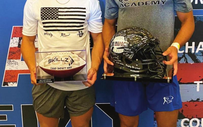 Camden Crooks and Blaze Berlowitz hold their MVP trophies at the QB Impact Academy football camp held at AT&amp;amp;T Stadium in Arlignton, Texas.