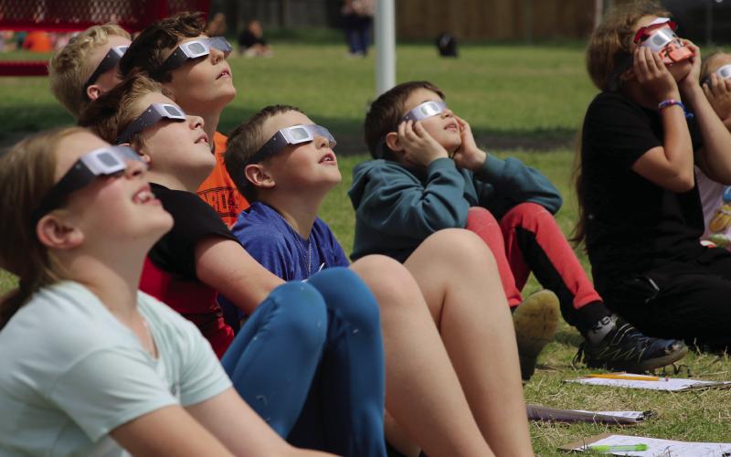 Ms. Munday’s fourth grade class at Cushing Upper Elementary school watch the solar eclipse as it reaches near totality Monday, April 8. Photo by Allie Prater