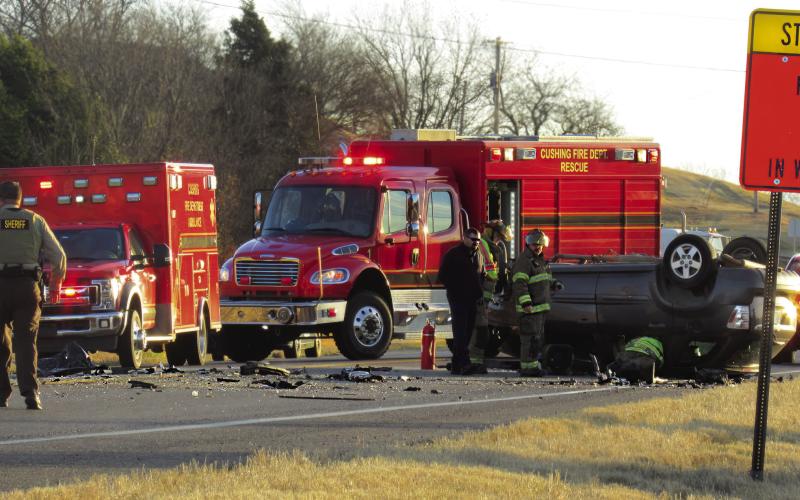 Members of the Cushing Fire Department and the Payne County Sheriff’s Department work the scene of a triple fatality just west of Cushing on SH 33 last week.
