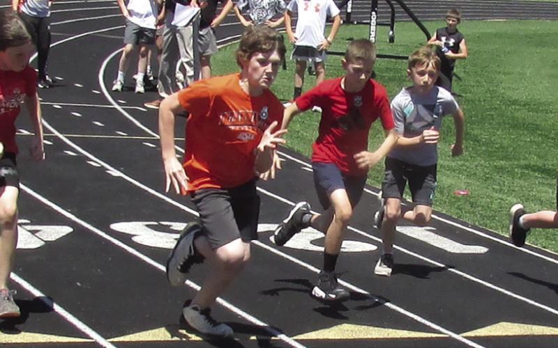 Ethan Church has an early lead during the fifth grade boys 100-yd dash. Participants pictured from left are Landon Thrasher, Church, Teagen Wood, Tyson Carmichael, and Tyler Harrison. Photos by DeAnna Maddox