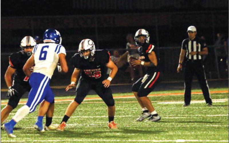 Quarterback John Hilligos looks for an open receiver. He threw for 290 yards last week and three TDs.