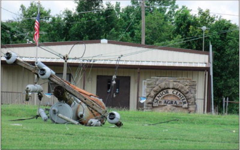 A fallen power line pole lays in front on the senior center in Agra. Photo by DeAnna Maddox.