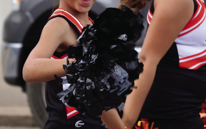 CUE cheerleader Malia Vernon cheers on the Tigers during the 2025 Homecoming Parade in historic downtown Cushing.