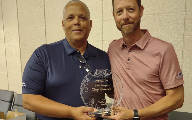 Left: Left: Freshly retired city manager Terry Brannon stands with interim city manager Derek Griffith during Brannon’s retirement party Friday, June 28.