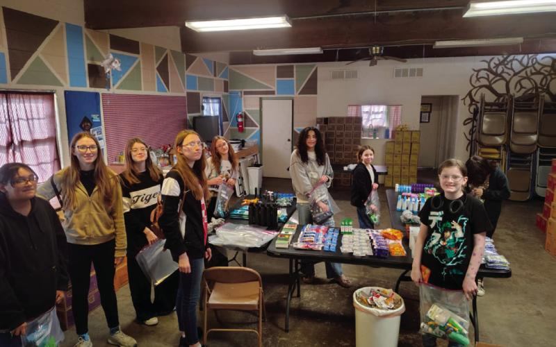Troop #79 members who were present to package hygiene bags were Tegan Fincher, Kira Keyes, Willow Keyes, Bella Keyes, Rhylynn Garcia, Aubrey Roberson, Everley Ewy, Alice Green, and Brooklyn Pierce. Additionally, Arhyanna User, Alexa Page, Addilyn Fox, Addison Kidder, Sadie Maxwell, Teagan Williams, Vaeda Nugent, and Vivian Richard also contributed items to be donated but were unable to attend the packing party.