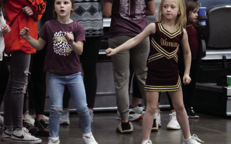 Ellis Billingslea (left), and Lainey Pitts (right), cheer on the Warriors in their 40-34 victory over OBA in the Area semi-final.