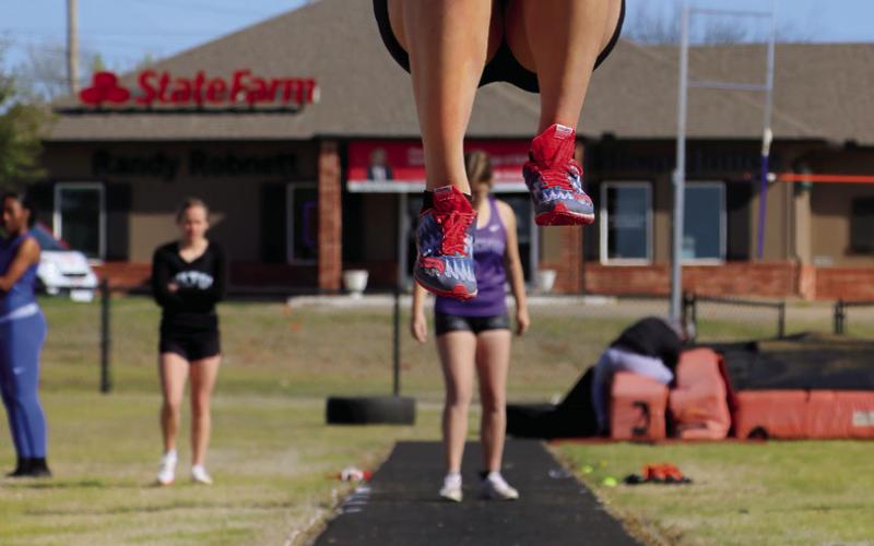 Lady Warrior Brooklyn Howell takes her qualifying leap in the long jump event at the Cushing Crossroads relay, Thursday, March 28. Photos by Allie Prater.