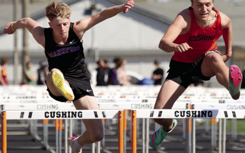 Mannford’s Grant Pierce goes head to head with Cushing’s Jasper Skelnik in the 300m hurdles.