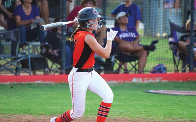 Below: Senior Jolie Oliver watches her deep single to center fly. Oliver’s shot brought the Lady Tigers to within one point and staged the go-ahead run at second.