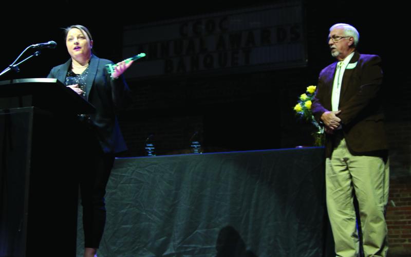 Cushing Pride Director Laura Green accepts the award for volunteer of the year from retired Director Richard Thackray.