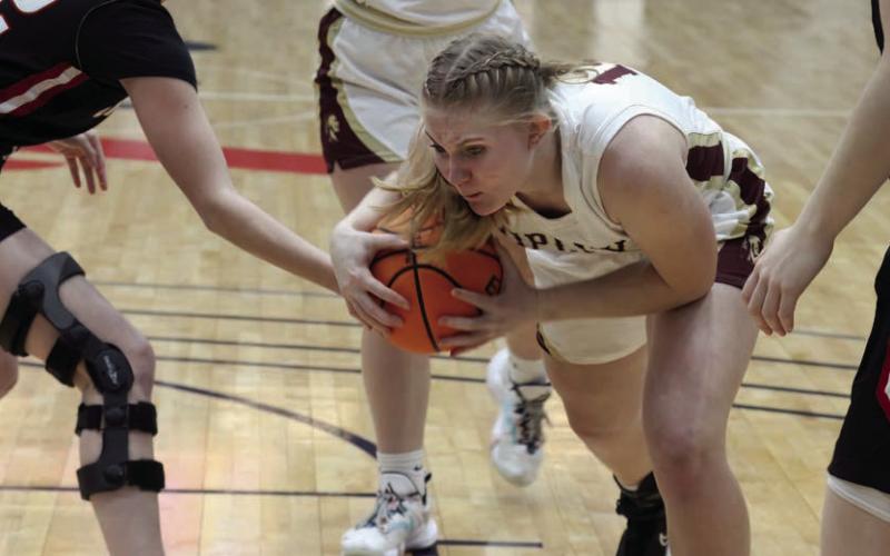 Brooklyn Howell powers through OBA defenders on her way to the basket. Photo by Kaleb Tadpole