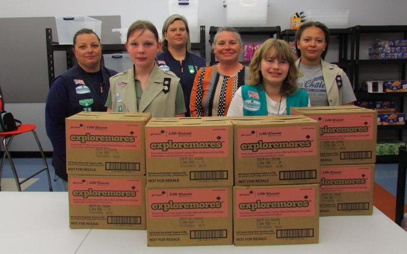 Pictured in back, from left is Troop 79 leader Laura Green and Karen Schmitt-Page with Cushing Middle School staff member Missy Hogrefe. In front, from left stand troop members Teresalyn Parson, Vivian Richard, and Alexa Page with several boxes of donated Girl Scout cookies. Not pictured are troop members Hannah Toops, Sadie Maxwell, Addilyn Fox, Arhyanna Tusler, and Samantha Cantrell.
