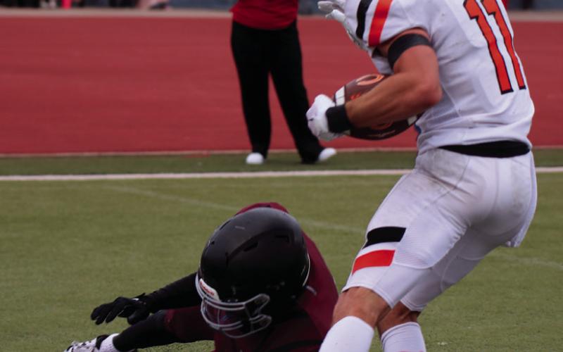 Brady Matheson fights his way toward the endzone Thursday. Photos by Cindy Waylan