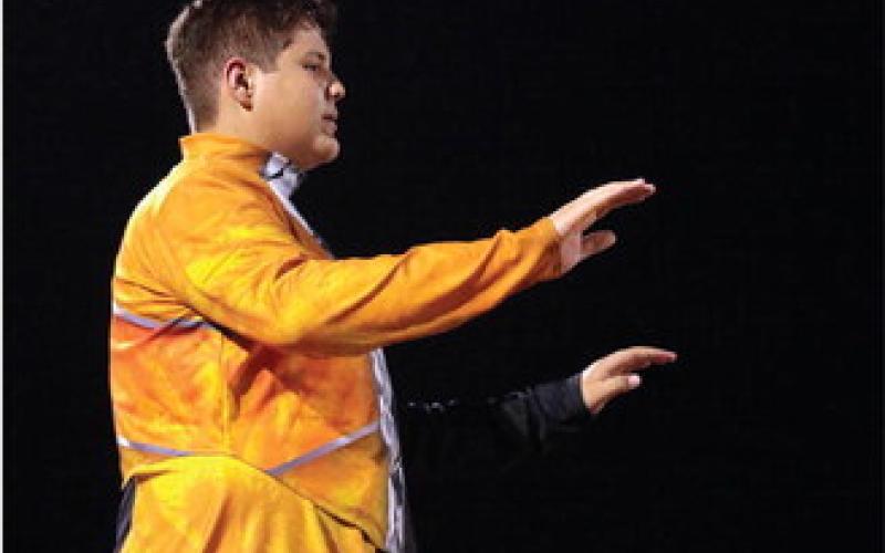 Drum Major Tyler Norman directs the Tiger marching band during its halftime performance.
