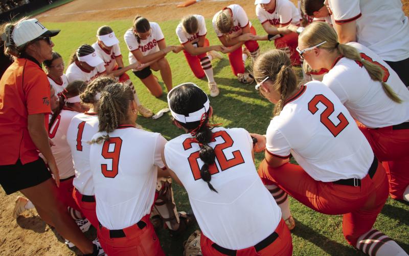 The Cushing Lady Tigers circle up for a pregame pep talk from Lady Tiger Head Coach Nikki York before the Lady Tigers took on the Davenport Lady Bulldogs in the season opener Monday, Aug. 10. See inside for more details. Photo by Allie Prater.