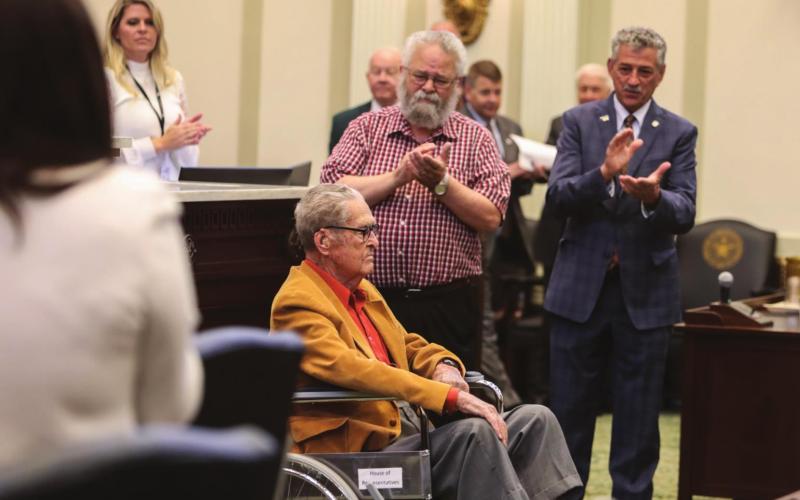 WWII veteran Sgt. Burton Richard Coate on the fl oor of the Oklahoma House of Representatives with his son Richard Coate and Rep. John Talley.