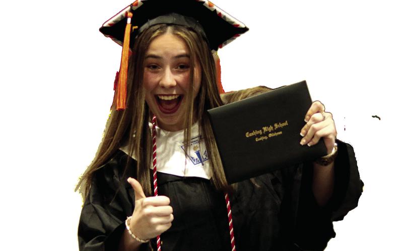 Cushing High School graduate Cassie Davis gives a successful smile and a proud thumbs up to the camera after receiving her diploma during CHS graduation ceremonies Friday. Photo by J. D. Meisner