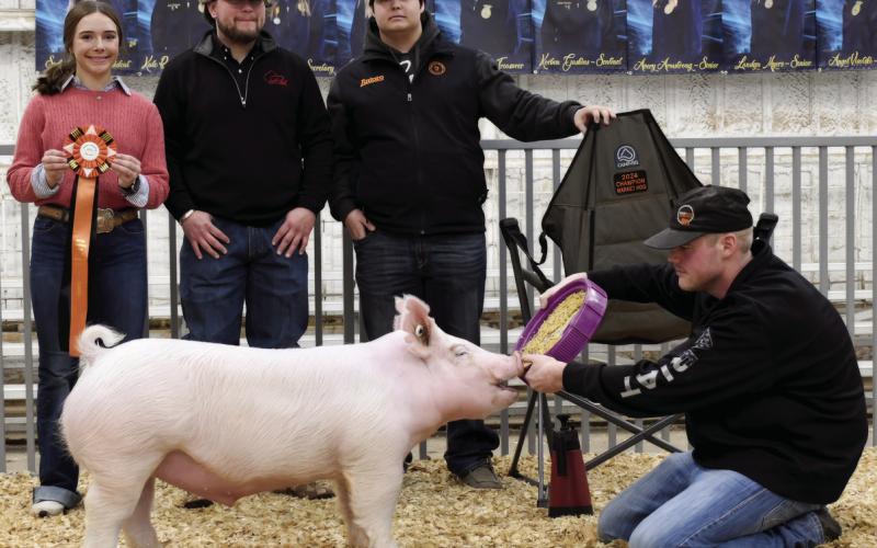 Cushing High School student Melannie Townes stands with her entourage and her prize winning pig during the Cushing Pipeline Classic Invitational Swine Show.