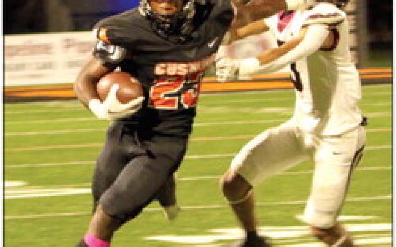 Noah Jones pushes off a would-be tackler as he turns the corner toward open field. Jones rushed for 113 yards and scored three touchdowns Friday.