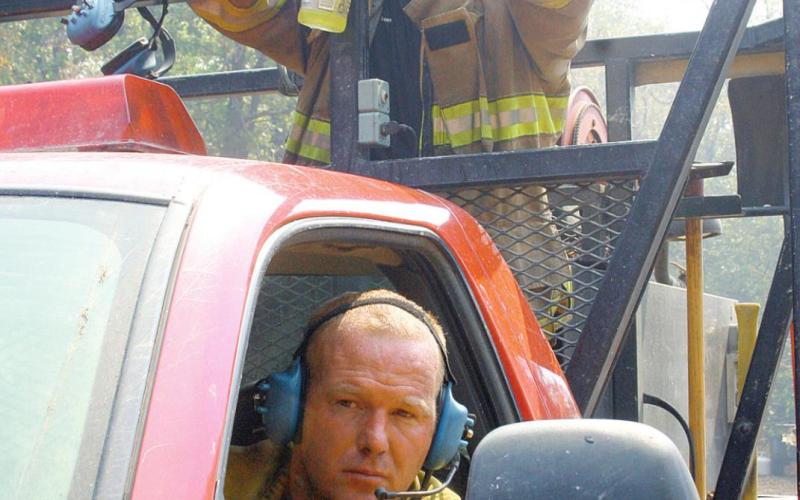 Members of the Glencoe Fire Department hydrate and prepare to go back into action as they battle the 2012 blaze.
