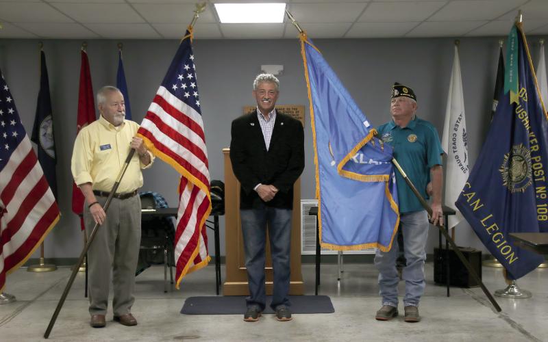 Past State Representative John Talley stands with Cushing American Legion Post 108 Commander Dennis Fisher and Post 108 Vice Commander G.W. Davis on Monday, Nov. 25. Talley donated the flags that flew in his office during his time as the State Representative for district 33 to Post 108. Photo by Allie Prater.