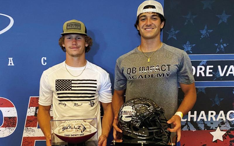 Camden Crooks and Blaze Berlowitz hold their MVP trophies at the QB Impact Academy football camp held at AT&amp;amp;T Stadium in Arlignton, Texas.