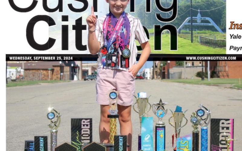 Connor Cline shows off his hardware in downtown Cushing. Photo by Allie Prater.