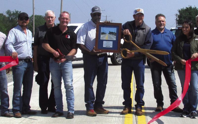 Commissioner Cavett performs the ribbon cutting in celebration of the long awaited completion of the Norfolk Road project which took a decade plus, two engineer companies, and $4.8 million.