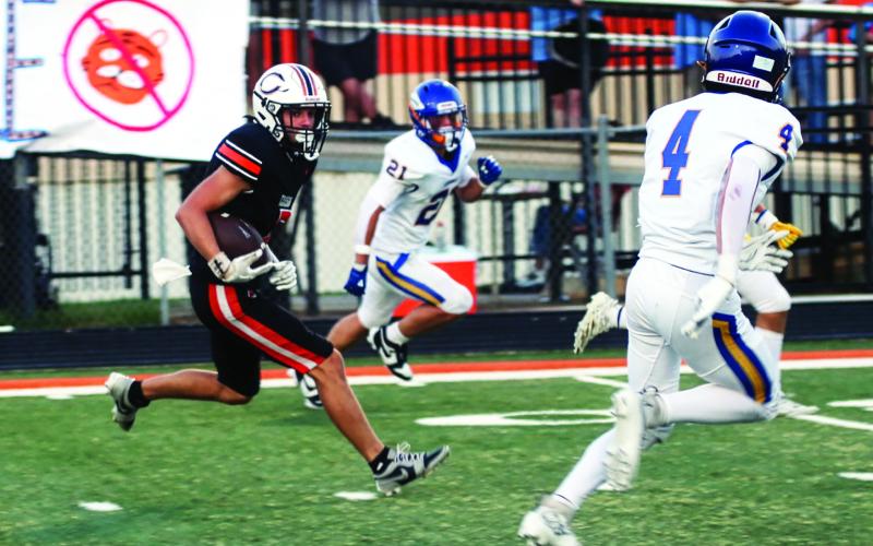 Lane Simpson sizes up the defense on his way to the end zone to score Cushing’s first touchdown of the night Friday. Photo by J. D. Meisner