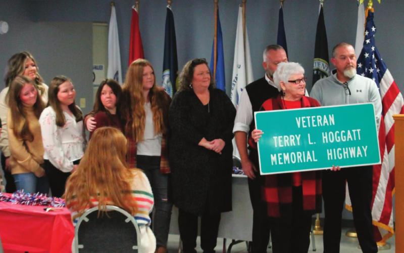 Representative Talley presents a ceremonial road sign dedication to the multitude of family members of Terry Hoggatt during the dedication held at the American Legion Post 108 on Nov. 11.