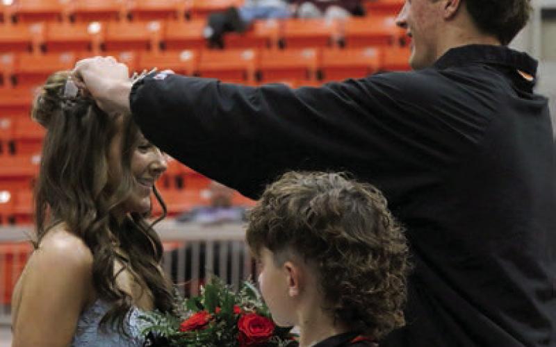 King Bryce Ward crowns Queen Laramie McCoy as crown bearer Easton Wright watches on. Photo by Allie Prater
