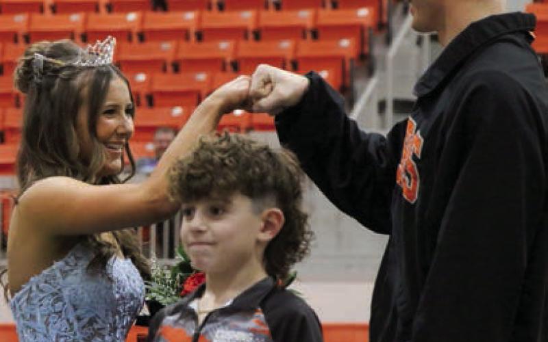 Queen Laramie McCoy and King Bryce Ward fist bump after being crowned king and queen. Photo by Allie Prater