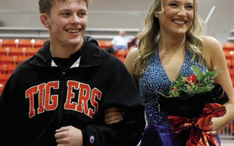 Cash Stapleton escorts Emery Turner following the coronation ceremony. Photo by Allie Prater