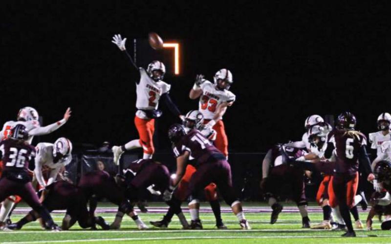 Lane Yaunt gets some serious height and defl ects a Blanchard extra point attempt, paving the way for the Tigers to grab a lead late in the fourth in their heartbreaking 14-19 loss to the Lions.