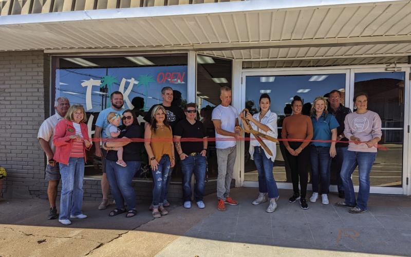 Chamber of Commerce members attended the ribbon cutting ceremony for Tiki Hut located at 221 North Cleveland Avenue, on Friday, Oct. 14. Pictured from left are John Rhoten, Tanya Rhoten, Geoff Beasley, Shawnee Ralston holding Lilah Beasley, Dana Cramer, Brandon Wolff, Tera Shooley, Tiki Hut Co-Owner Brian Demark hold the scissors with Owner Naveah Taylor-Tennison standing to the left of Co-Owner Carol Medford, Chamber President/CEO Tracy Caulfield, John Moran, and Sarah Townes. Photo by Afton Pierce.