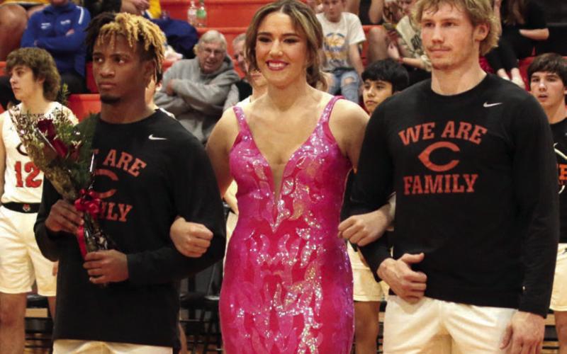 Noah Jones and Camden Crooks escorting Tatum Caulfield.