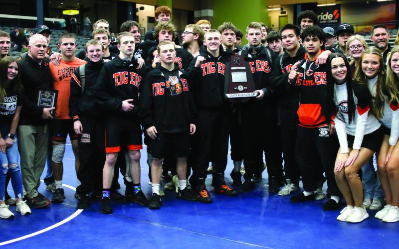 The Cushing Tiger wrestling family stands with a runners-up plaque commemorating their second place win at the OSSAA Dual State Tournament in Enid Friday, Feb. 9. See inside for more details. Photo by Allie Prater.